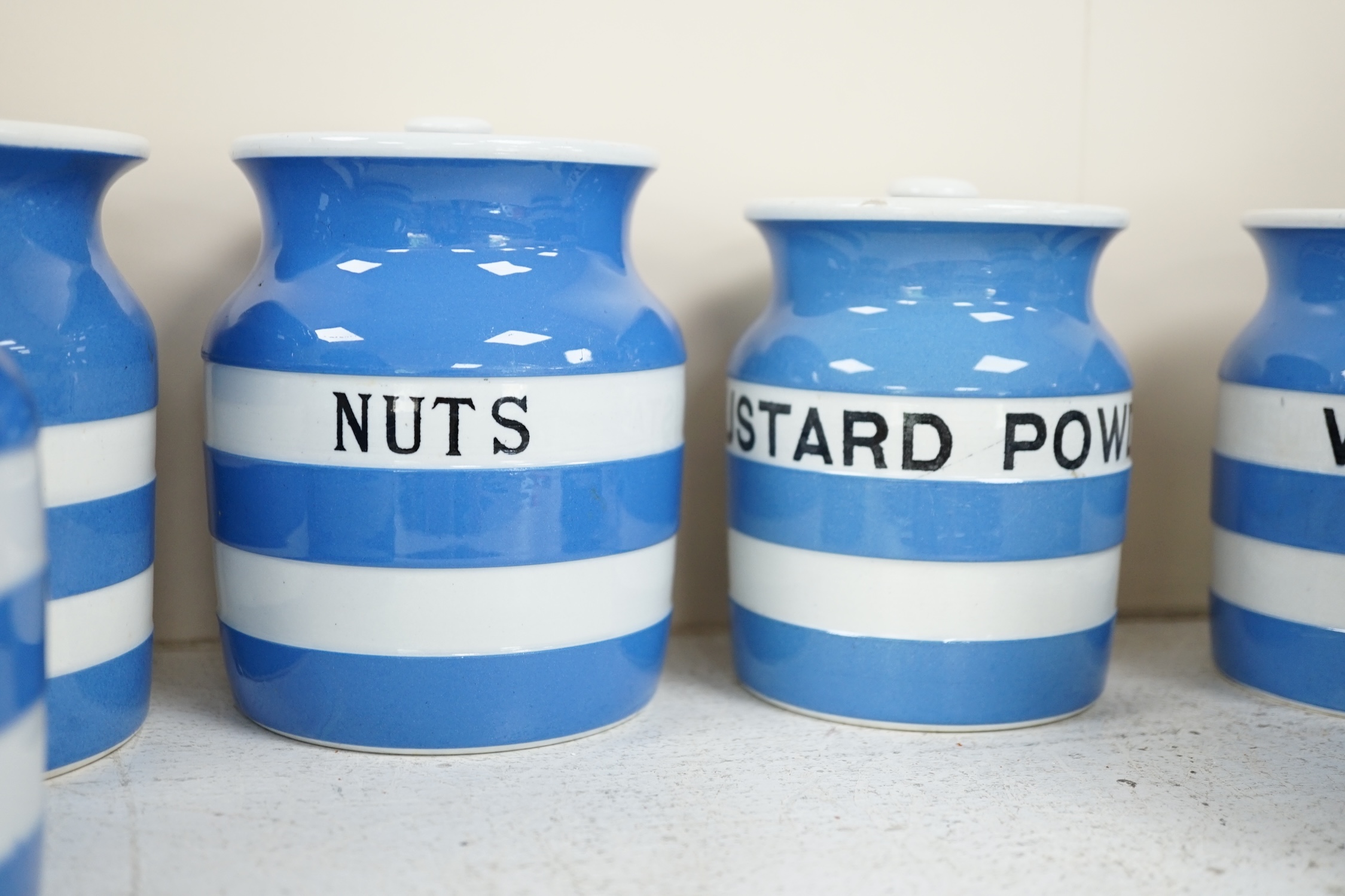 T.G.Green Cornish Kitchenware, ten 12cm and 11cm lidded storage jars to include Pectin, Split Peas, Sesame, Custard Powder and Walnuts, Black Shield marks. Condition - fair to good